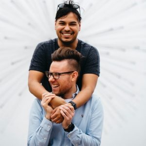 happy-gay-couple-manifesting-love-hugging Happy gay couple manifesting love and hugging.