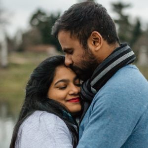 man-in-blue-manifesting-love-kissing-woman-on-forehead Man in blue manifesting love and kissing woman on forehead.