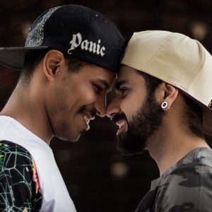 two-smiling-men-manifesting-love-and-facing-each-other Two smiling men manifesting love and facing each other.