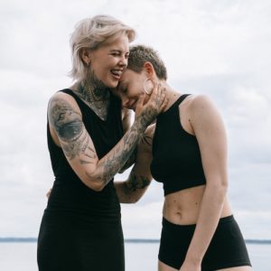 women-laughing-on-beach-and-manifesting-love Women laughing on beach and manifesting love.