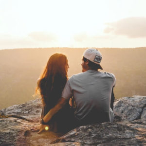 Couple watching the sunset and manifesting love Couple watching the sunset and manifesting love